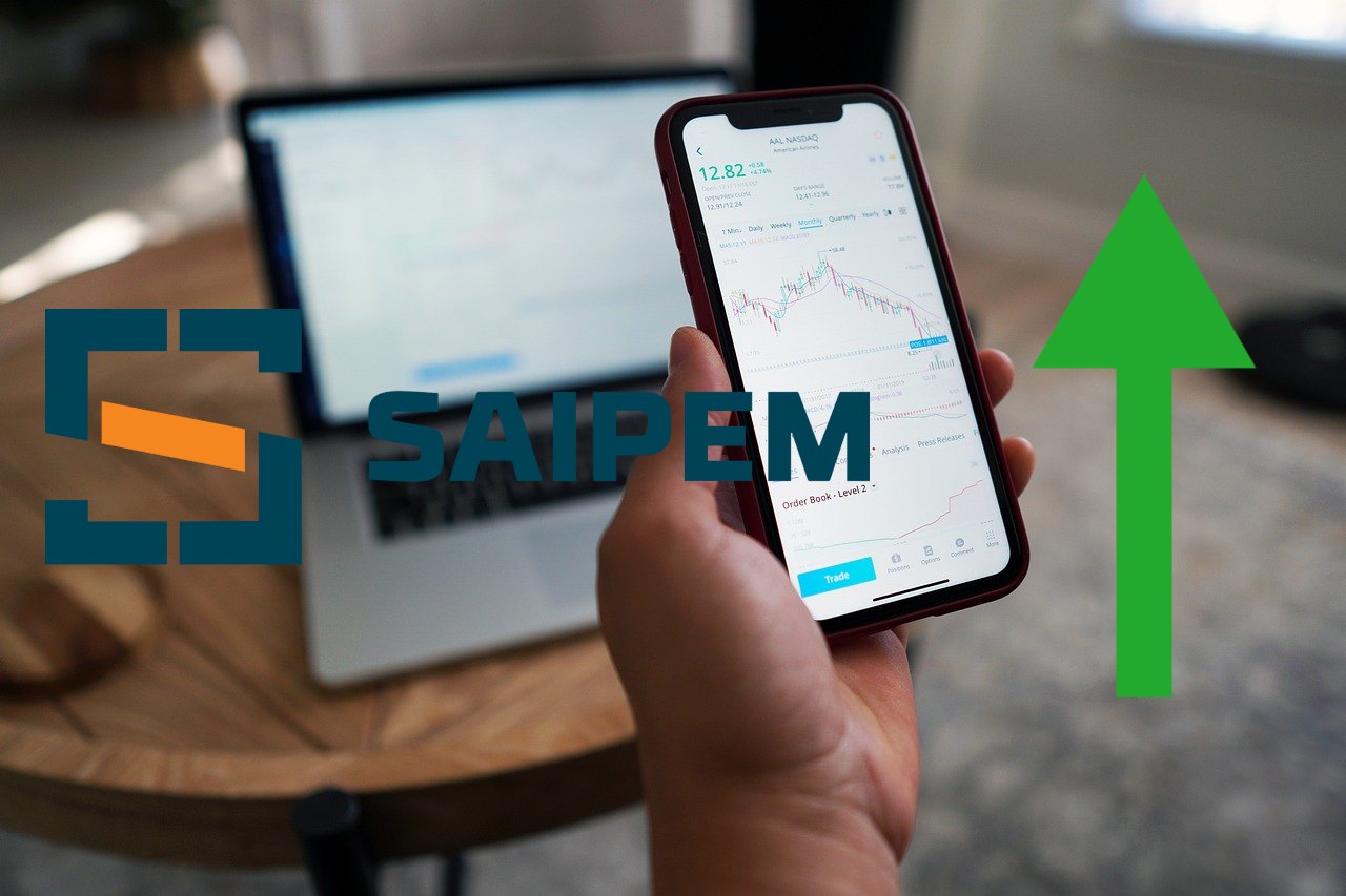 trader al lavoro e logo di Saipem